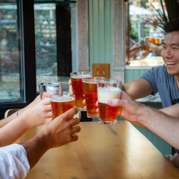 a woman sitting at a table holding a glass of wine
