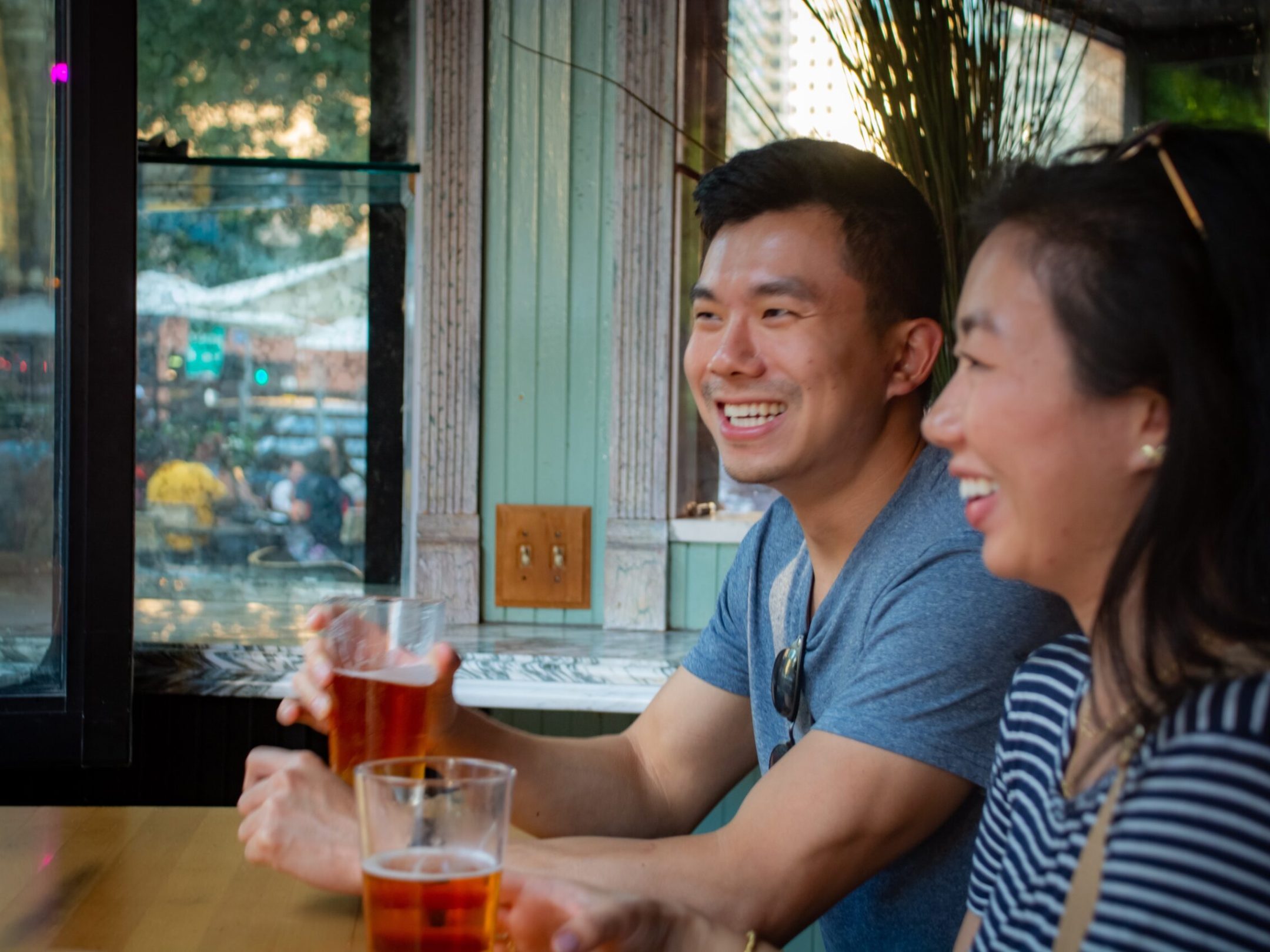 a woman sitting at a table in front of a window