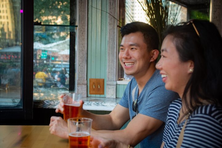 a woman sitting at a table in front of a window