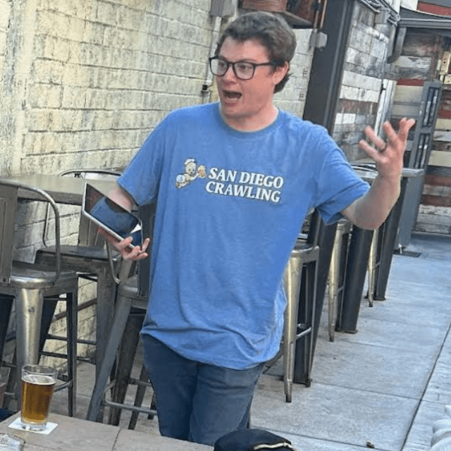 Screenshot 2025-05-09 at 5.03.30 PM a man standing in front of a building